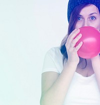 Woman blow the balloon for prepare the party