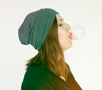 Woman eating and blowing bubblegum on white background