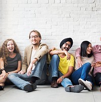 Diverse cheerful people sitting on the floor