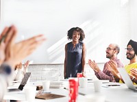 Woman getting an applause from people at the table