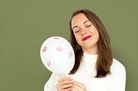 Young girl smiling holding a balloon