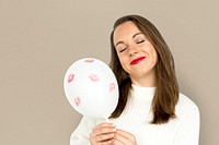 Young girl smiling holding a balloon