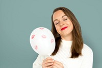 Young girl smiling holding a balloon