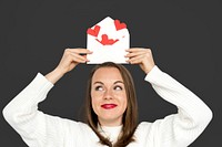 Woman holding envelope red paper hearts