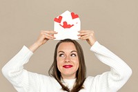 Woman holding envelope red paper hearts