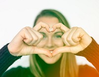 Happiness woman in love forming heart love hand sign
