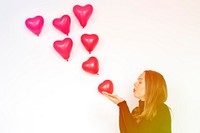 Woman blowing balloon heart love kiss