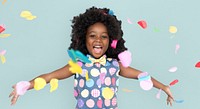 Girl with an afro enjoying colorful confetti