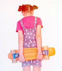 Little Girl Holding Skateboard facing other side