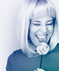Woman smiling and eating lollipop candy
