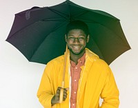 African man with umbrella and raincoat on white background