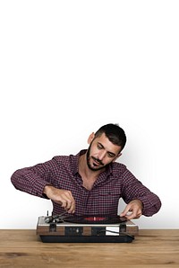 A man playing music using vinyl record instruments