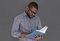 African descent man is reading a book