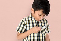 Boy amazed while looking through a magnifying glass