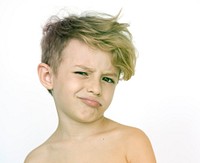 Young kid standing shirtless and posing for picture