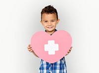 Boy holding a heart with a white cross