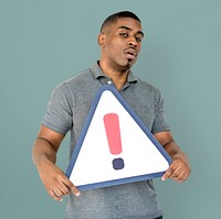 African Descent Man Holding Warning Sign