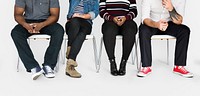 Body portraits of people sitting in a row of chairs waiting