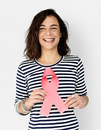 Casual young woman holding a pink ribbon representing breast cancer awareness