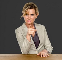 Businesswoman in a studio with wooden table