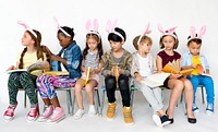 Group of children in a row with bunny head band.