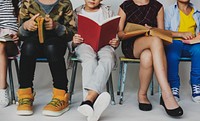A group of primary schoolers sitting and reading books