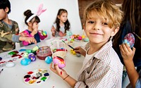 A group of primary schoolers colouring easter eggs