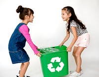 Two little girls moving a recycle box
