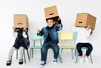 Group of children are playing paper box game.