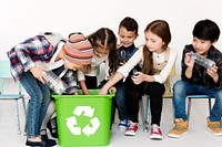 Group of children with a recycling symbol.