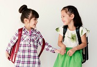 Girls Friends Studio Shoot Holding Hands Going to Schoolo White Background