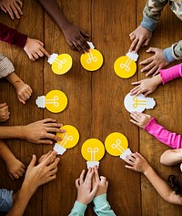 Group of children branstorming and sharing ideas with light bulb