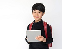 Little cute and adorable student boy using digital tablet is back to school