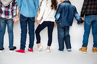 A group of young children holding hands