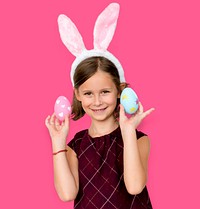 Kid with a bunny hairband holding eggs