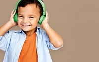 Young asian boy wearing headphones listening to music