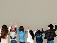 Group of children holding hand together in rear view