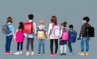 Rear view group of diverse kids standing in a row holdings hands