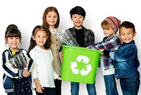 A group of young children recycling