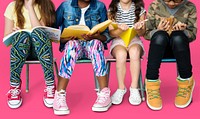 Diverse group of kids sitting in a row reading books