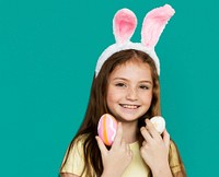 Children with bunny hairband and easter eggs