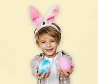 A boy with bunny hairband and easter eggs