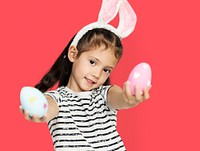 A girl with an easter eggs and bunny hairband