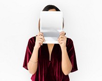 Woman holding blank digital tablet cover face studio portrait