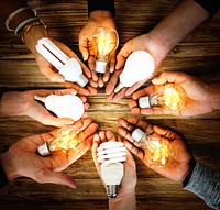 People holding light bulbs in their hands