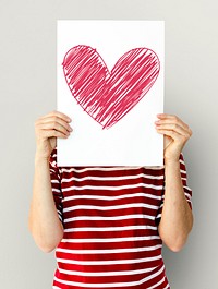 kid holding heart icon on a paper