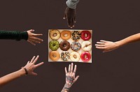 Group of hands reaching sweeten donut dessert