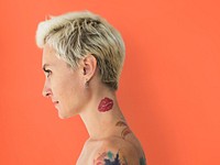Profile portrait of a blonde woman with tattoos