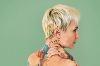 Portrait of a woman showing off her back tattoos