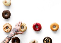 Hands selecting a variety of donut flavour